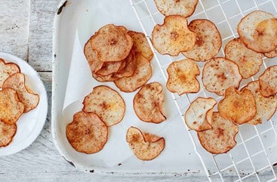 Some potato crisps scattered on a plate